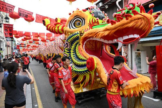 2月1日，由馬來西亞和中國的100多名青少年組成的舞龍隊在馬來西亞馬六甲市雞場街上共舞一條近200米的“長龍”。這是活動現(xiàn)場的“長龍”。新華社記者程一恒攝