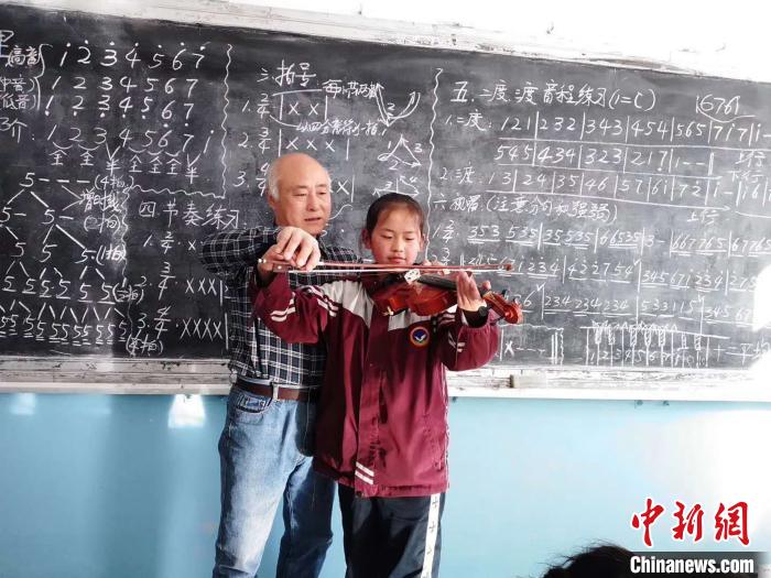 圖為趙興洲教學(xué)生拉小提琴。受訪者提供